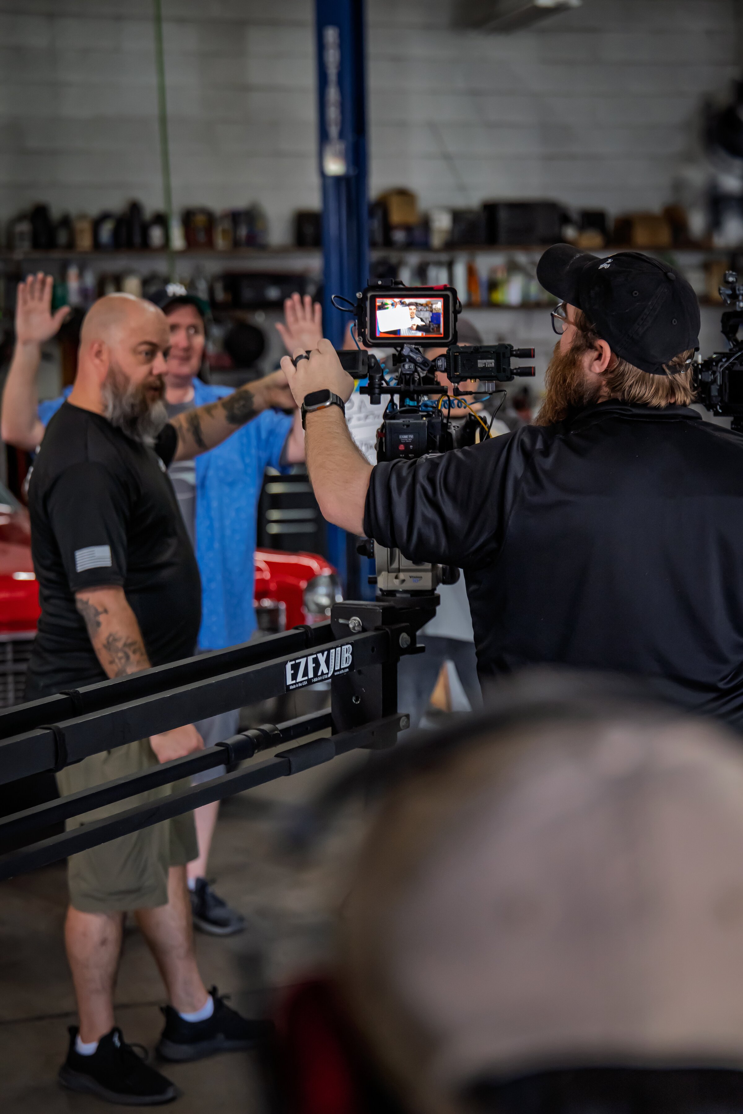 Crew members work together around a camera mounted on a jib.